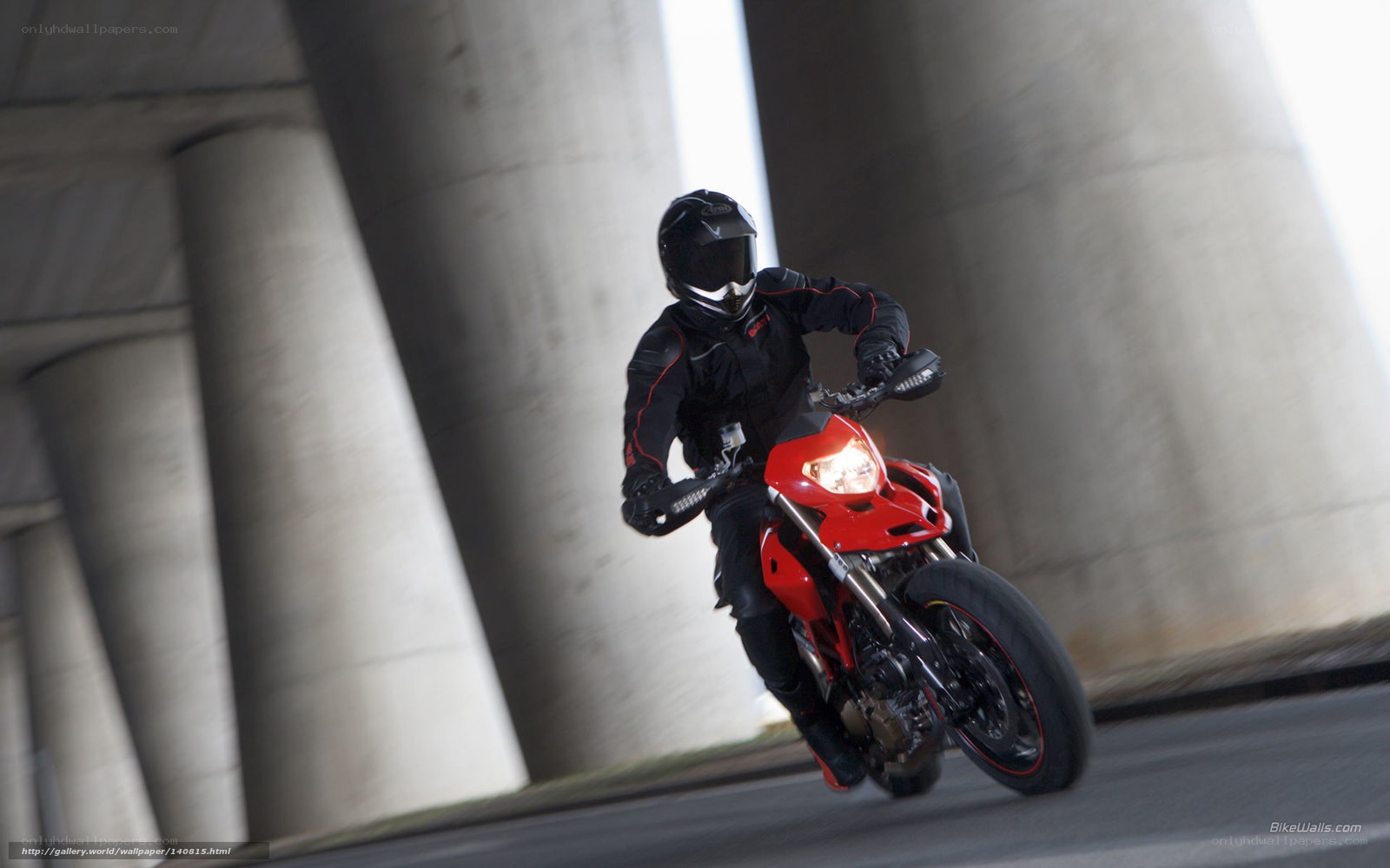 Motorcyclist under a bridge