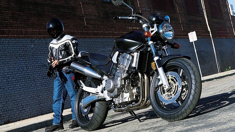 motorcyclist with bike on street