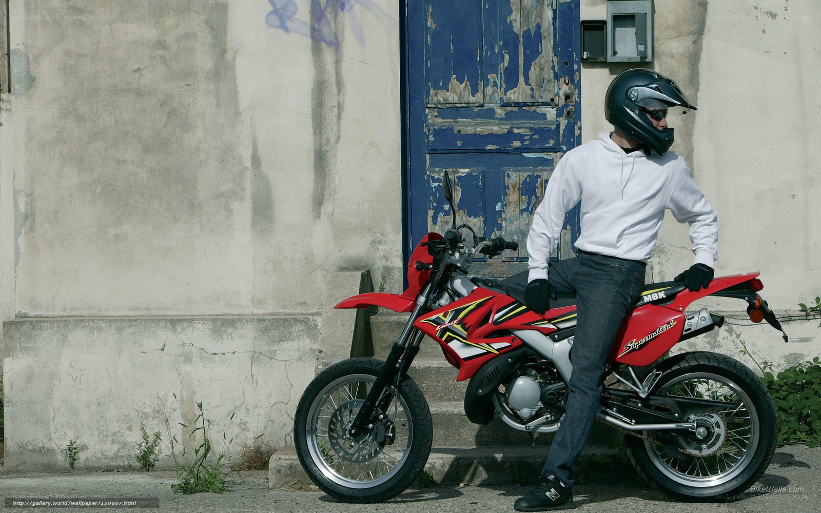 motorcyclist with red bike