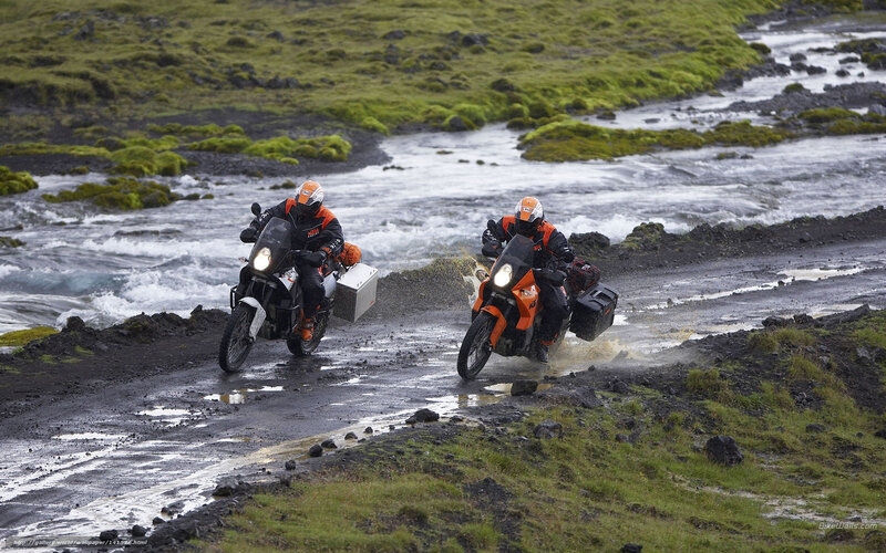Motorcyclists crossing a river