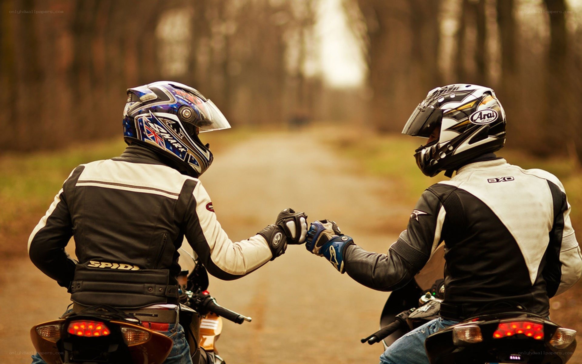 motorcyclists fist bumping