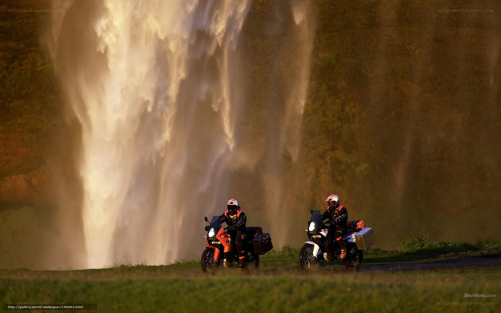 Motorcyclists near a waterfall