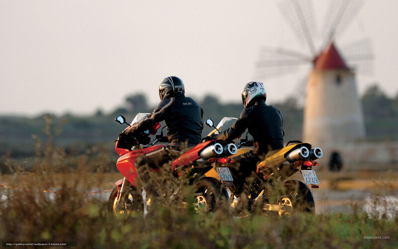 Motorcyclists near windmill