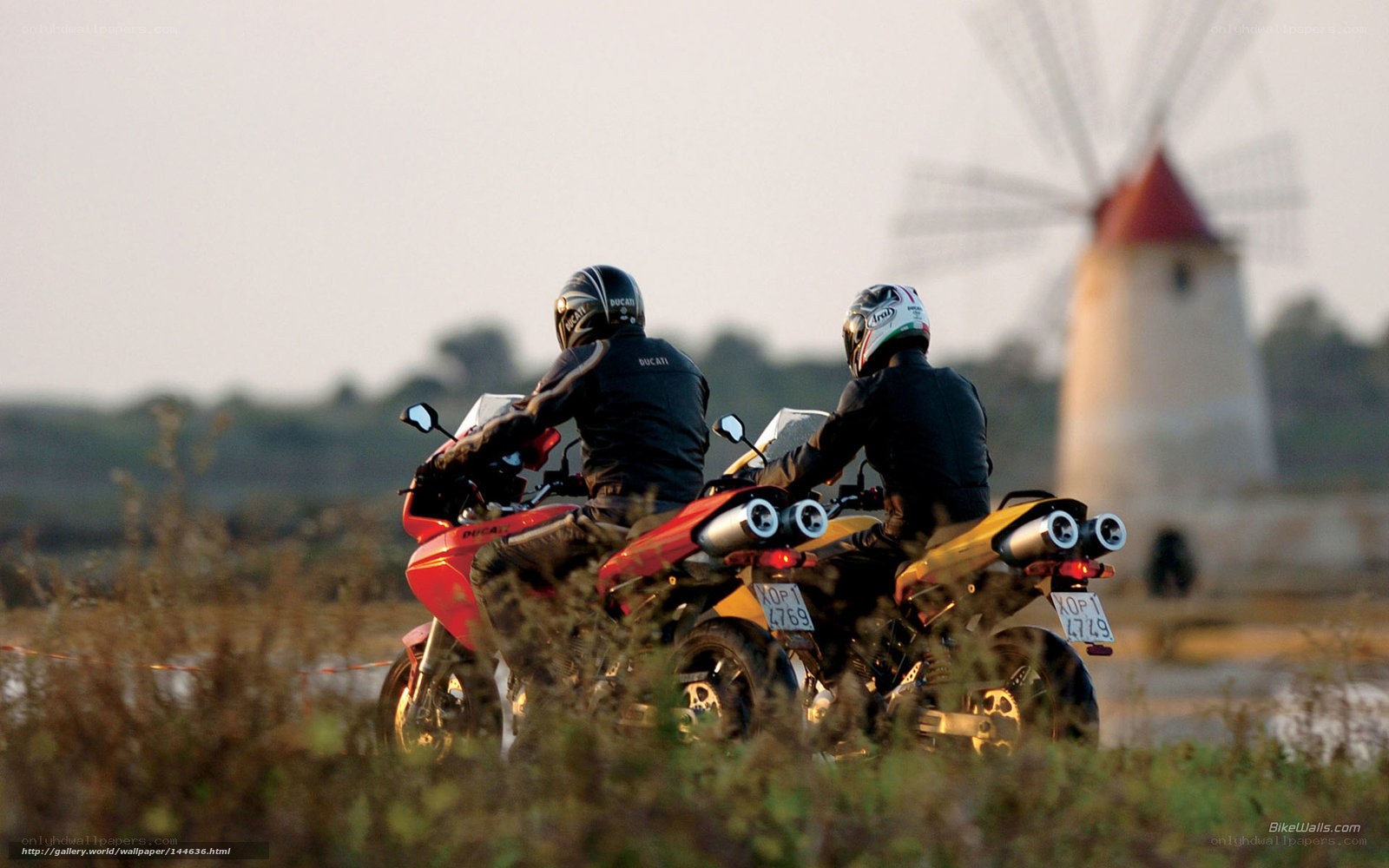 Motorcyclists near windmill