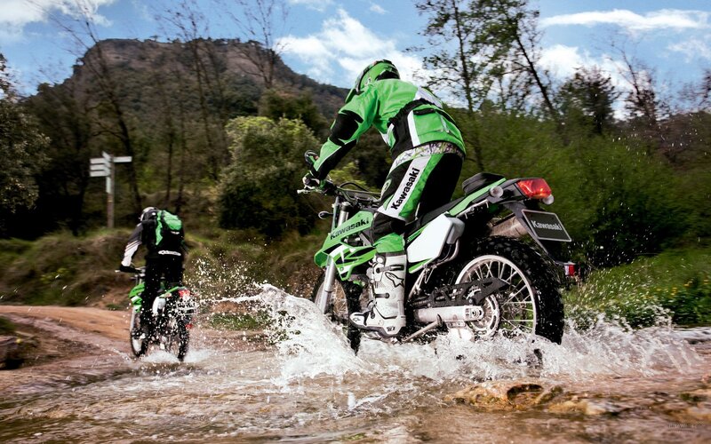 Motorcyclists riding through water