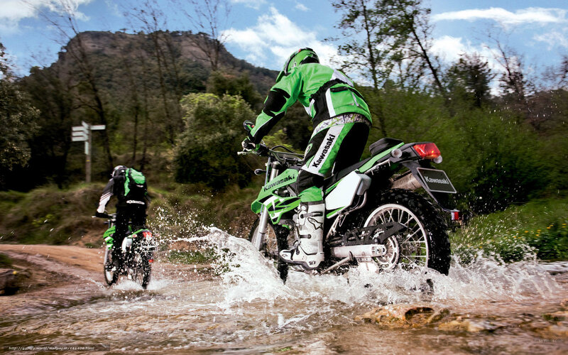 Motorcyclists riding through water