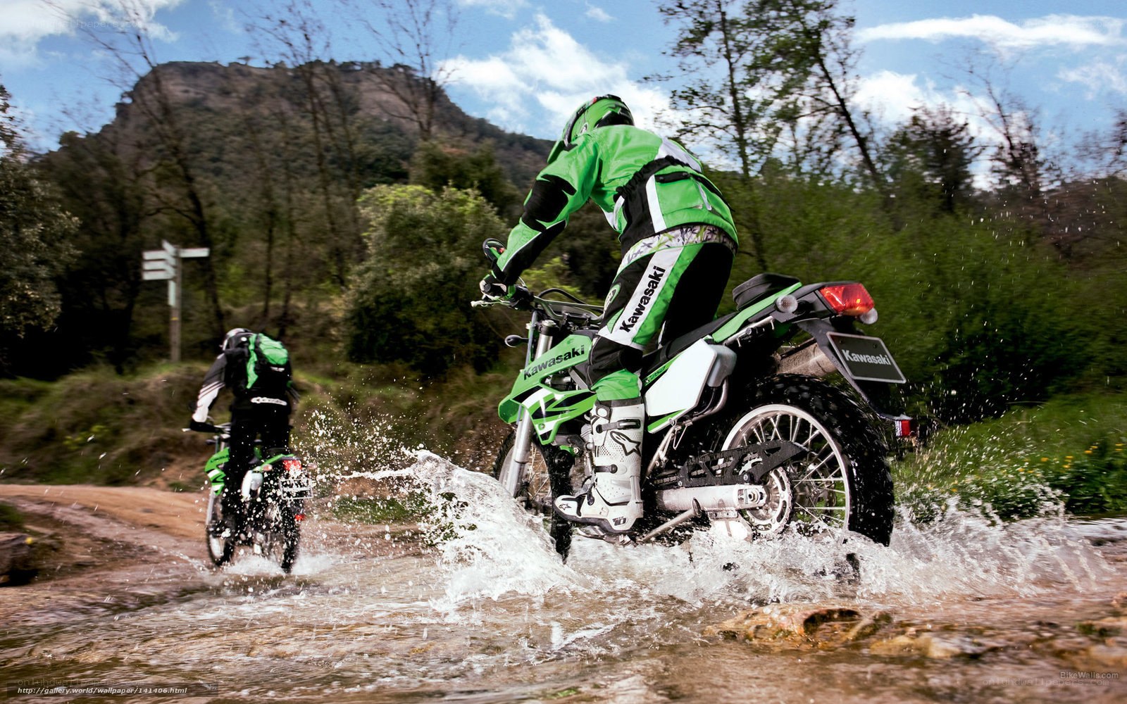 Motorcyclists riding through water