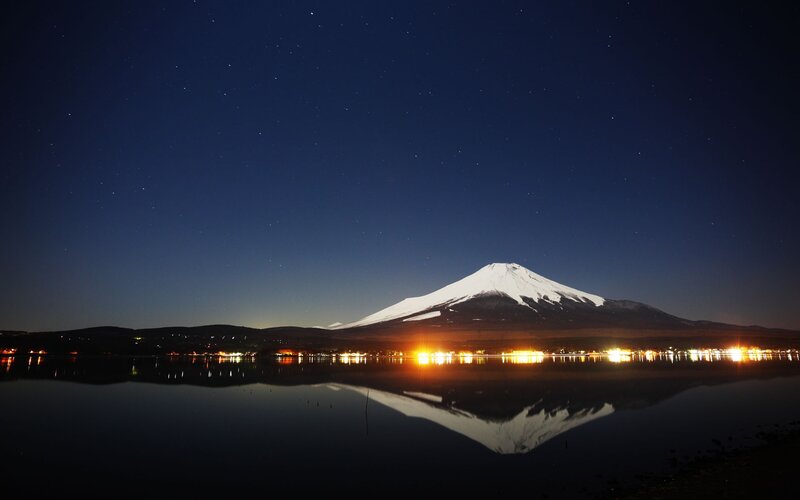 Mount Fuji at night with lake reflection