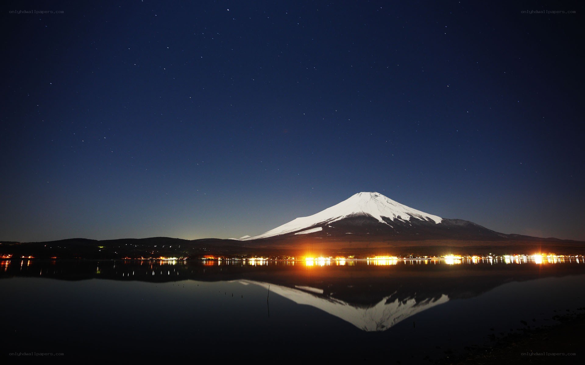 Mount Fuji at night with lake reflection