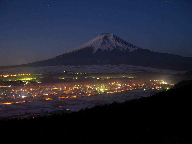 Mount Fuji at night with town lights