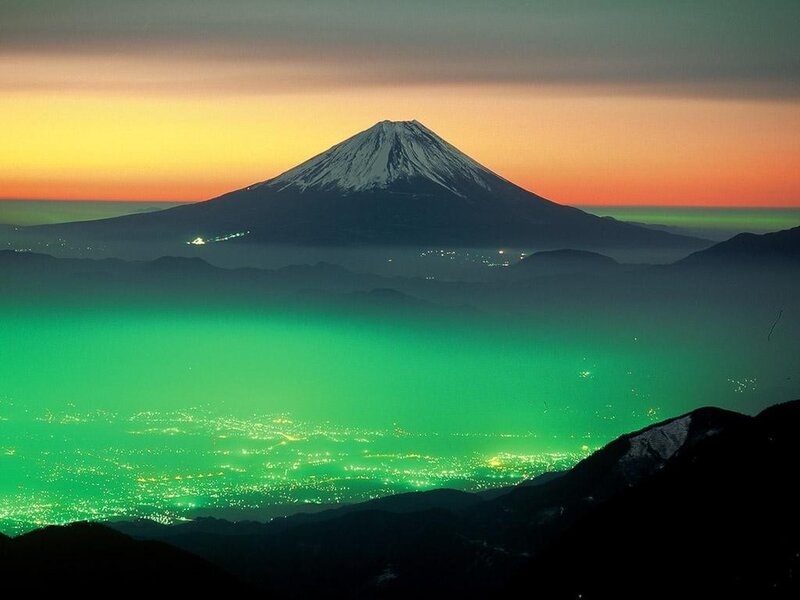 Mount Fuji at sunset with green aurora