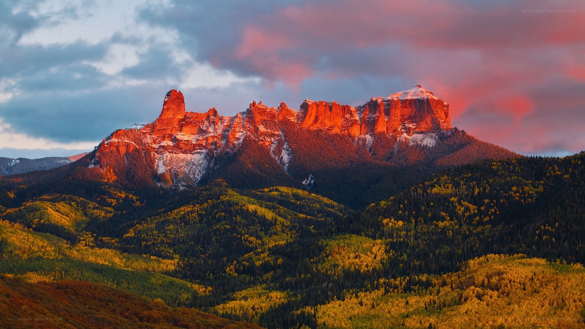 Mountain at sunset with autumn forest