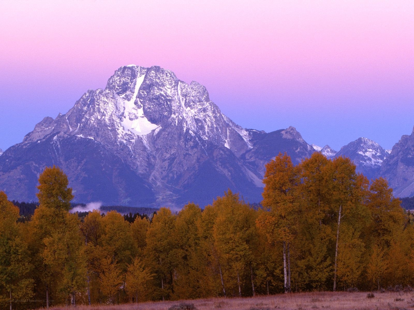 Mountain at sunset with autumn trees