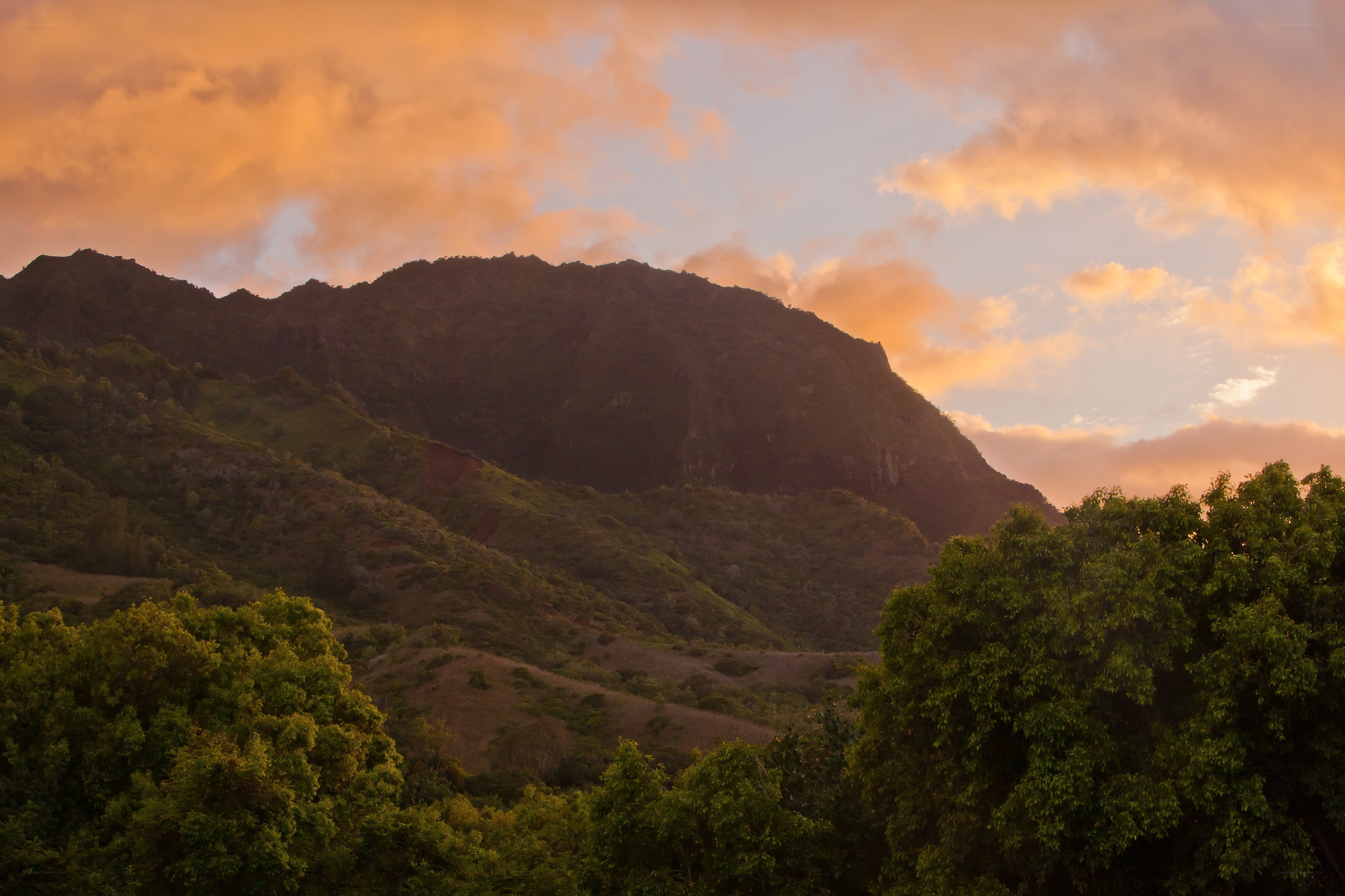 Mountain at sunset with orange sky