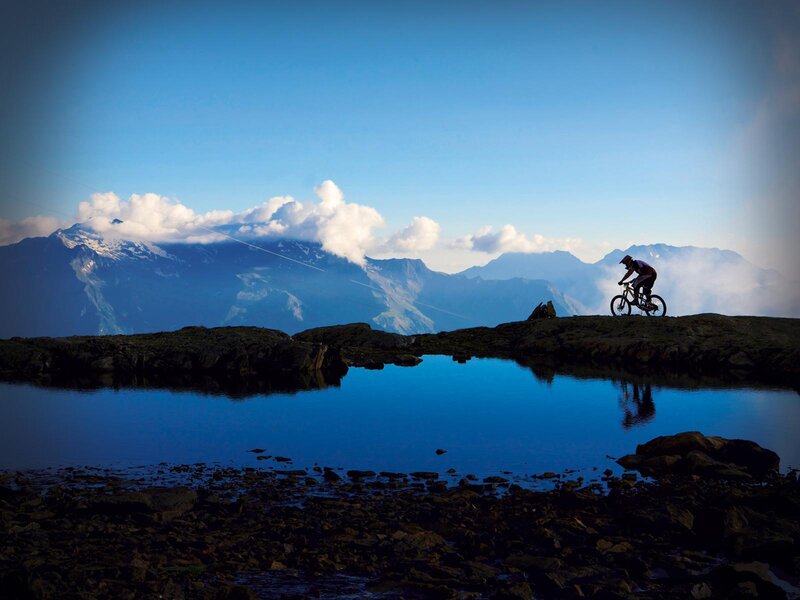 Mountain biker at alpine lake