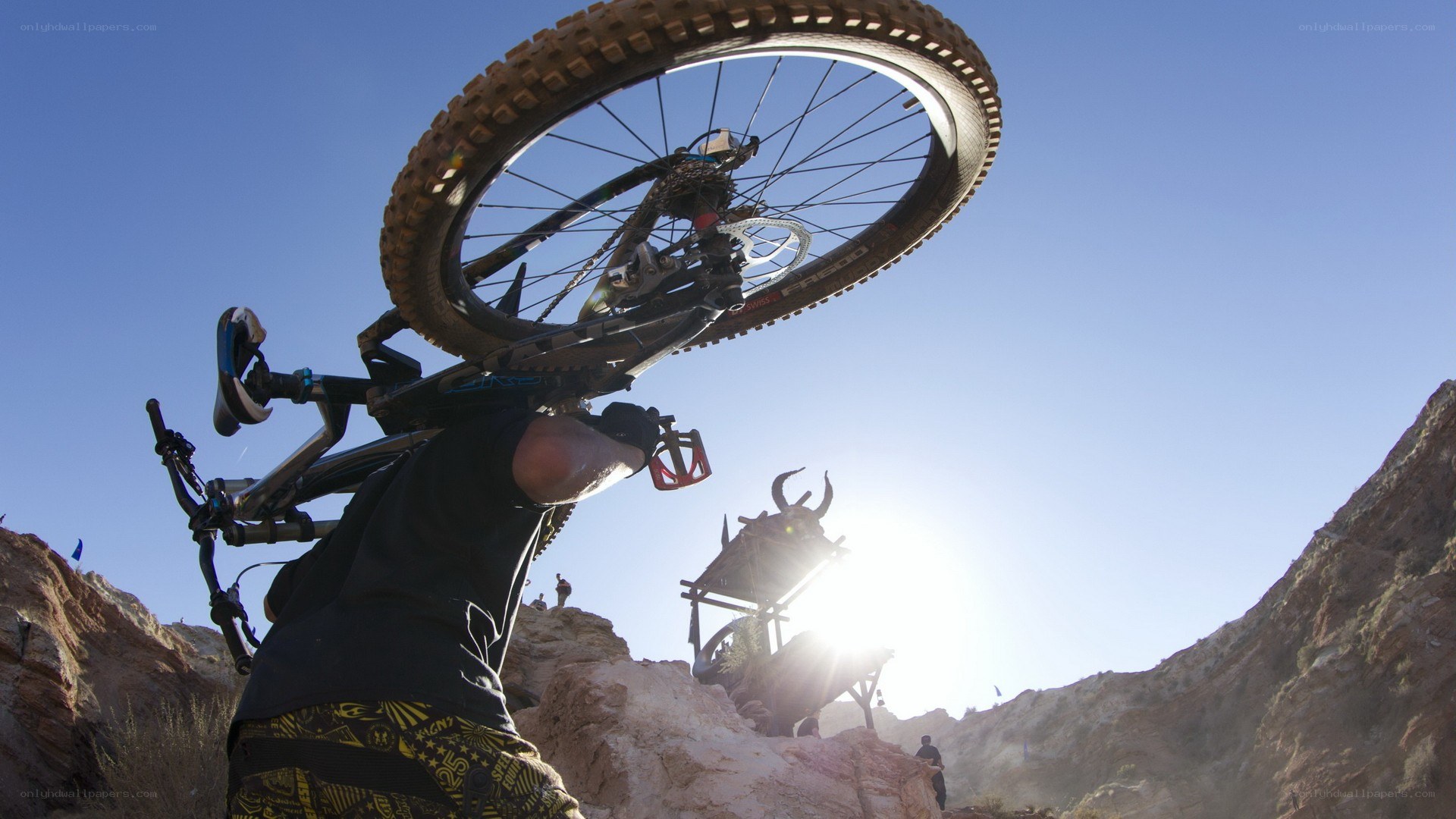 Mountain biker carrying bike