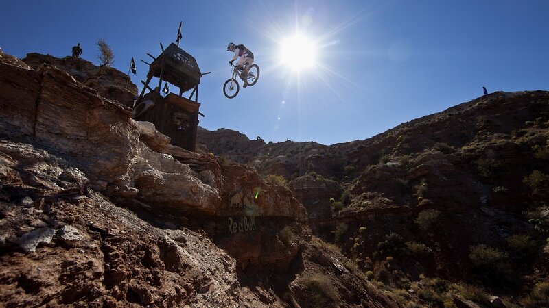 Mountain Biker in Mid-air — Blue, Dramatic, Afternoon, Photograph, Rocky Canyon