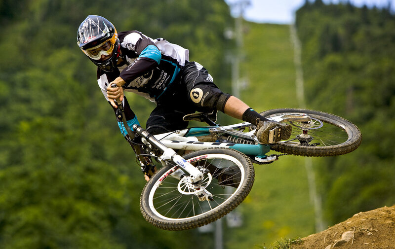 Mountain Biker in Mid-air — Green, Dynamic, Afternoon, Photograph, Helmet, Goggles