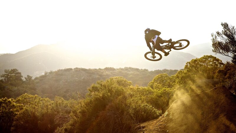 Mountain Biker in Mid-air — Green, Dynamic, Sunset