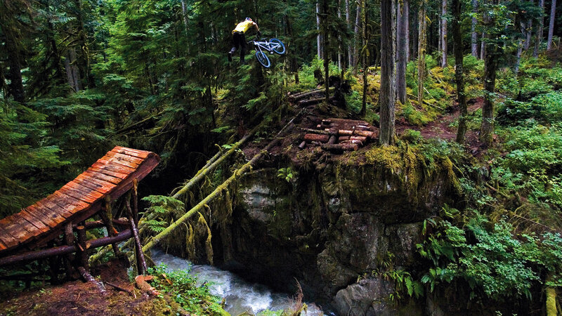 Mountain biker jumping over stream