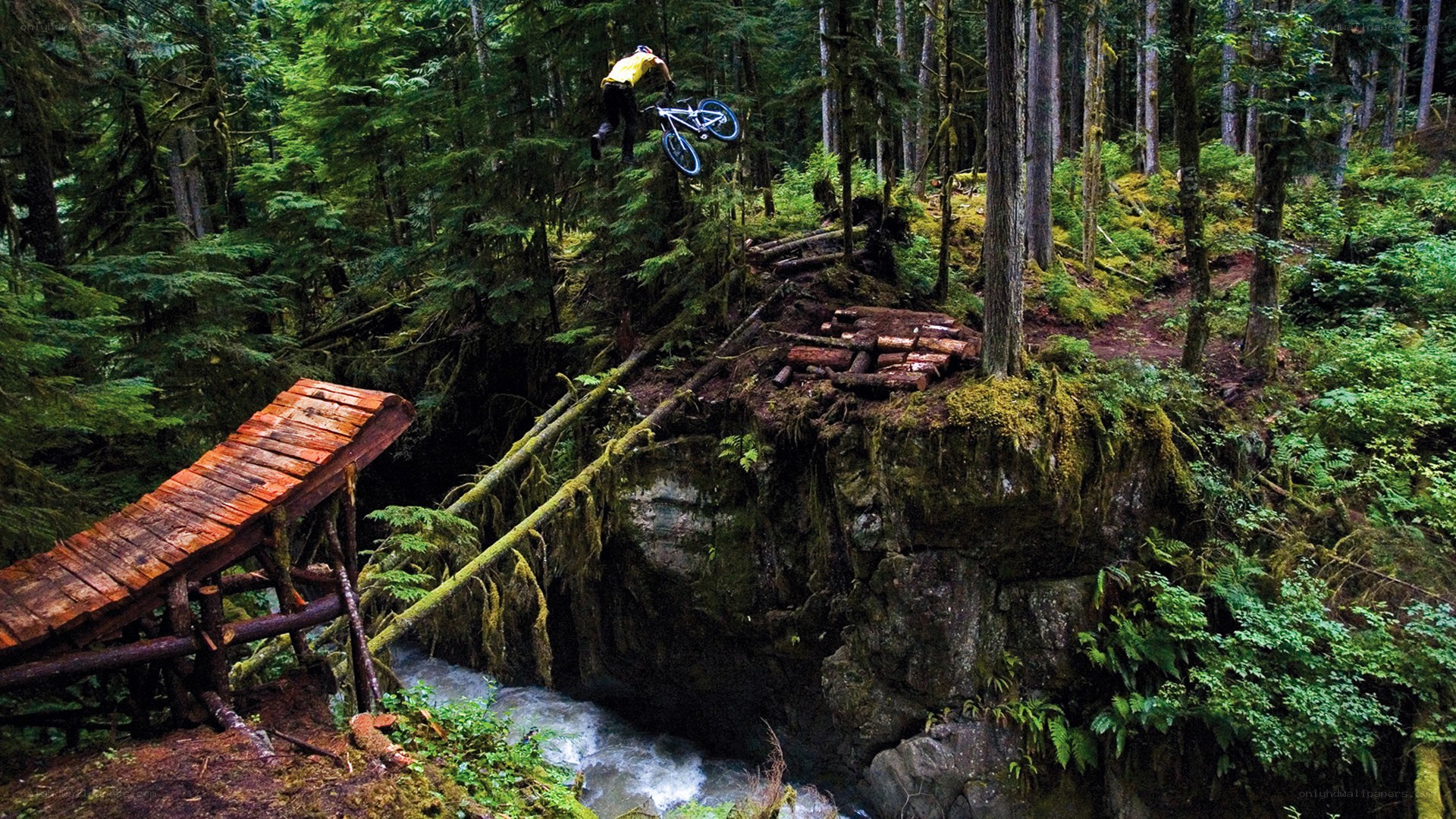 Mountain biker jumping over stream