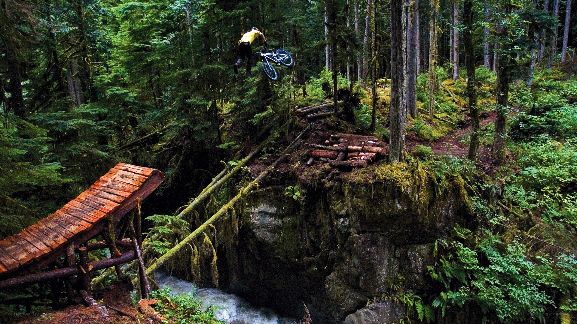 Mountain biker jumps over stream