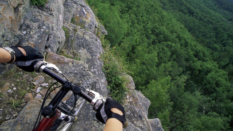 Mountain biker on a cliff edge
