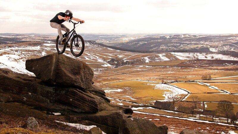 Mountain Biker on Rock — Brown, Dramatic, Winter