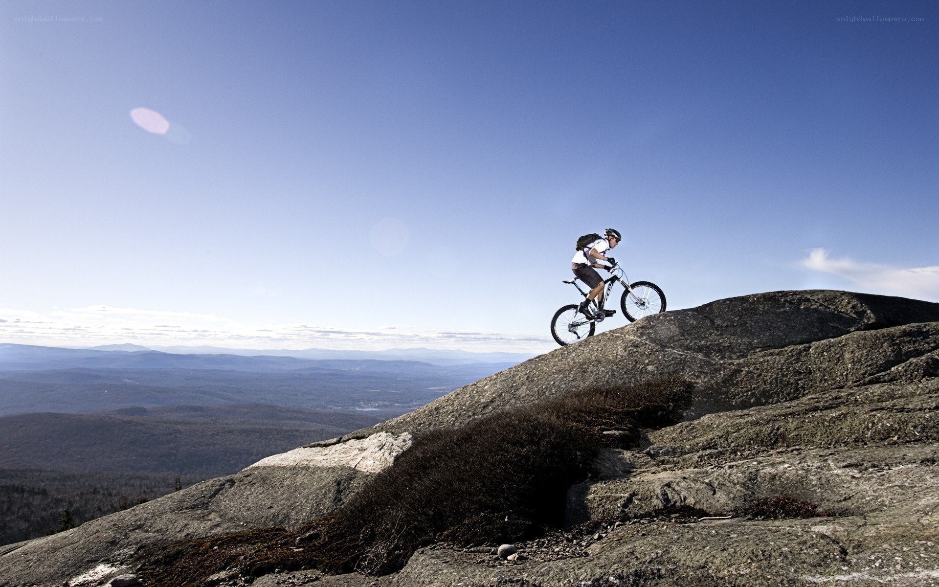 Mountain biker on rocky peak