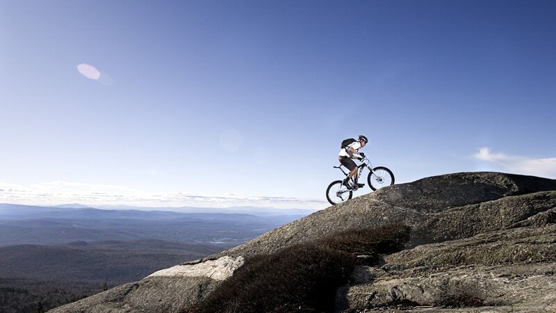 Mountain biker on rocky peak