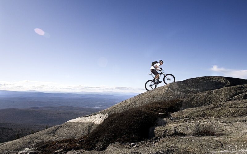 Mountain biker on rocky peak