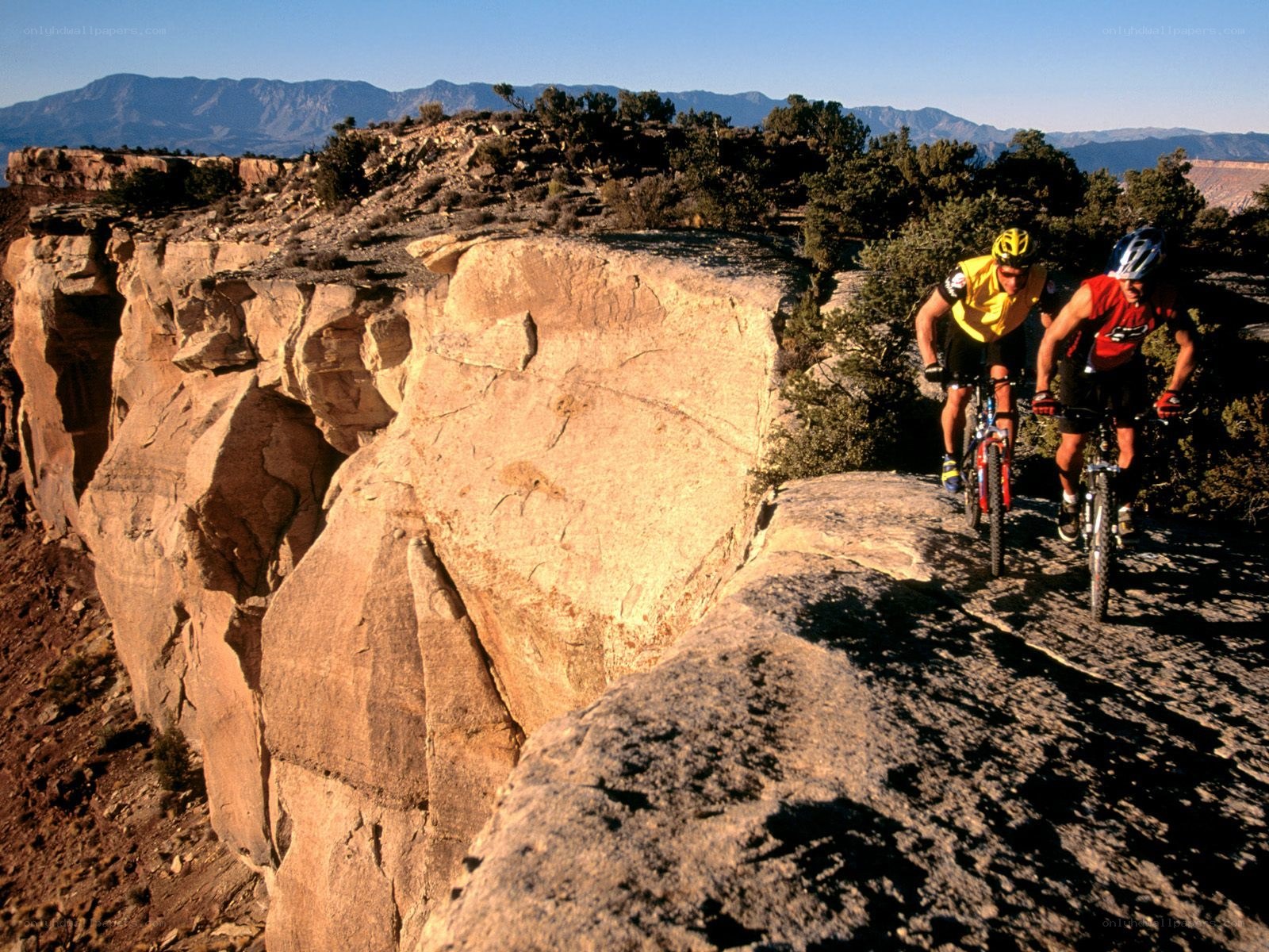 Mountain bikers on a cliff edge