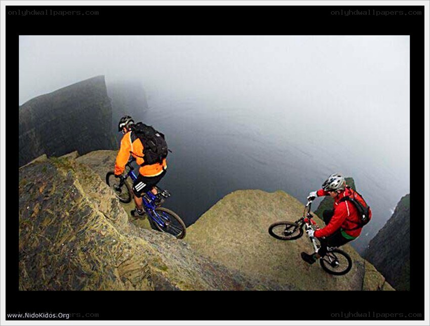 Mountain bikers on a cliff edge