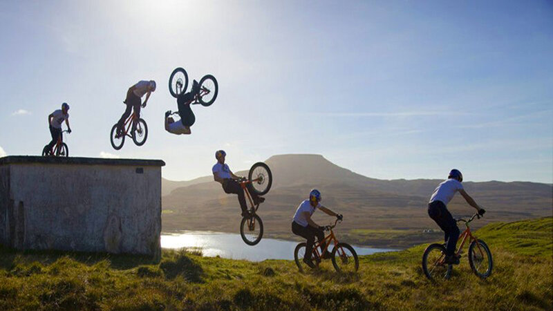 Mountain bikers performing stunts