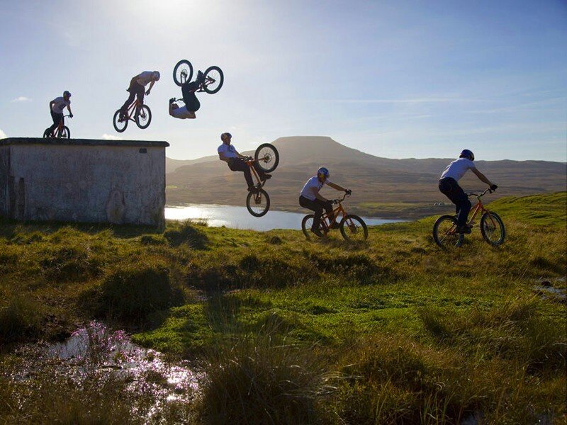 Mountain bikers performing stunts