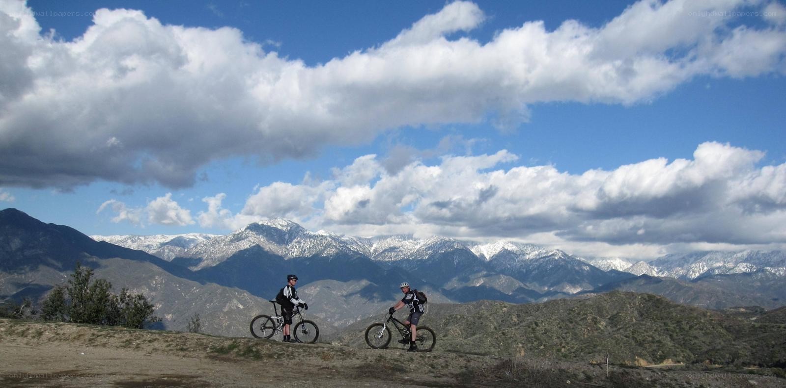 Mountain bikers with snow-capped peaks