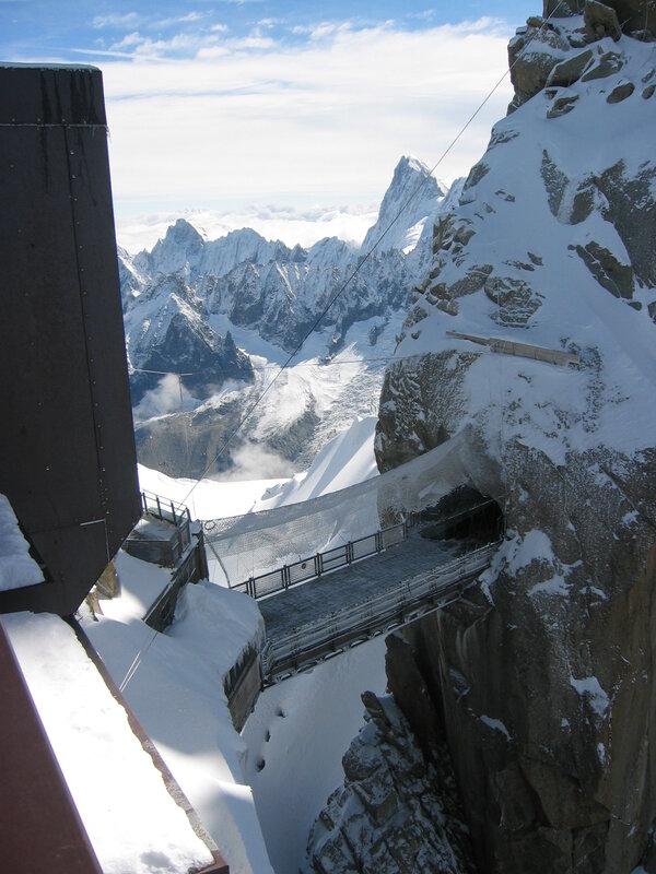 Mountain bridge with snowy peaks