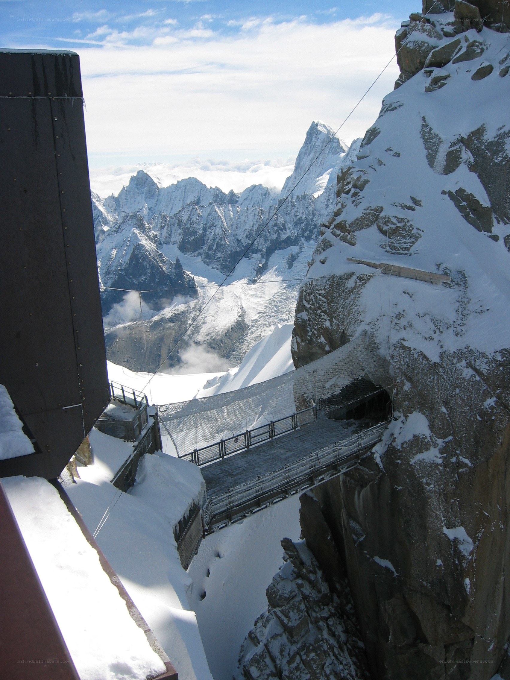 Mountain bridge with snowy peaks
