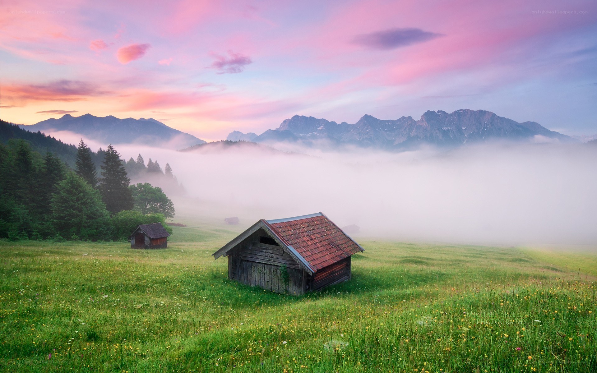Mountain cabin at dawn in fog