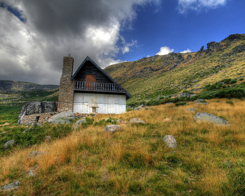 Mountain cabin in a grassy valley