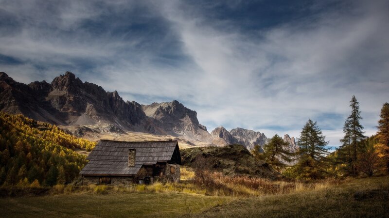 Mountain cabin in autumn landscape