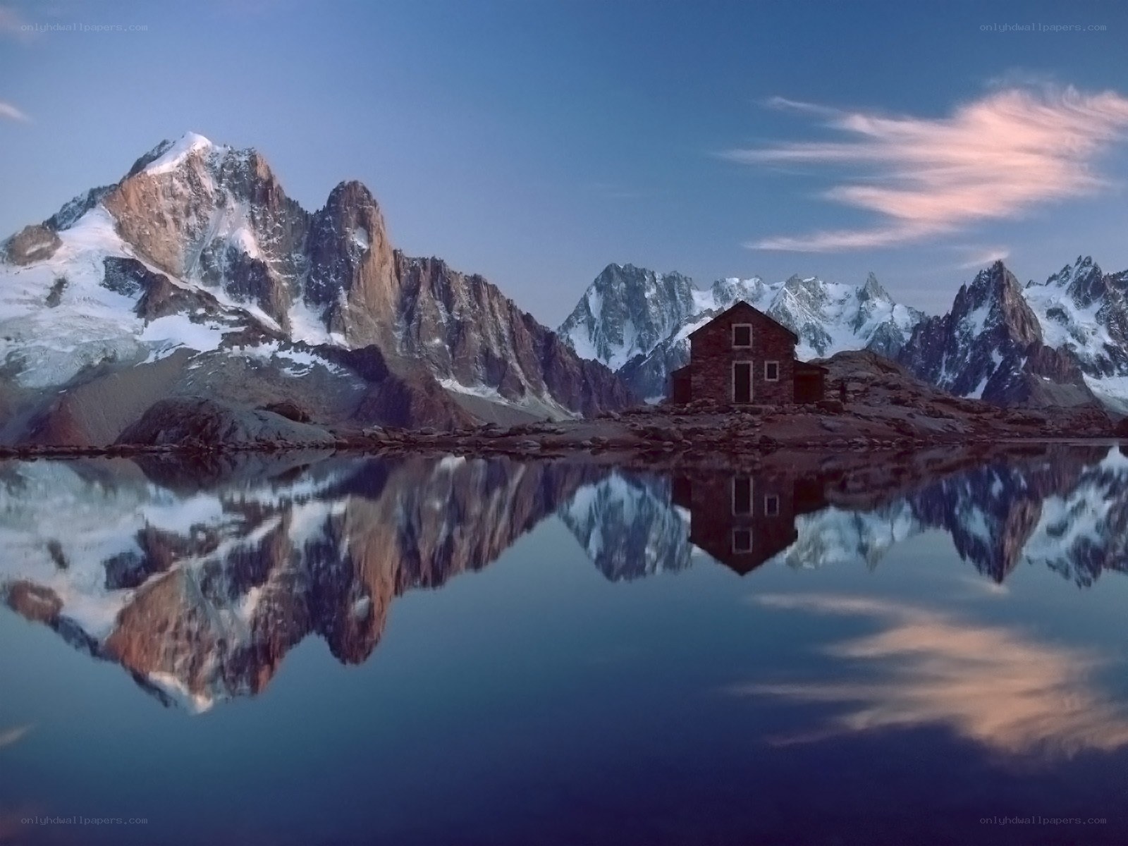 Mountain cabin reflected in lake