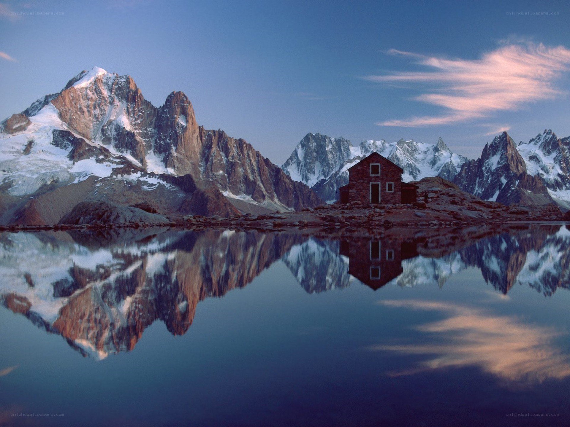 Mountain cabin reflected in lake
