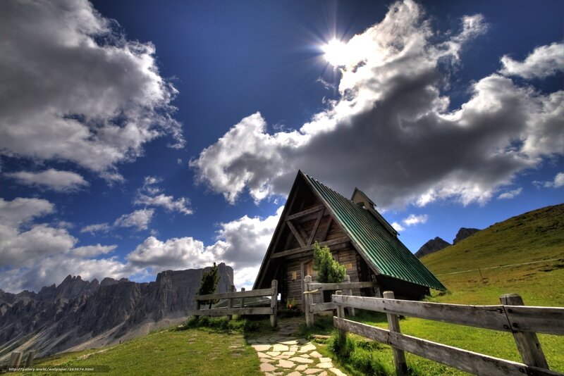 Mountain cabin under cloudy sky
