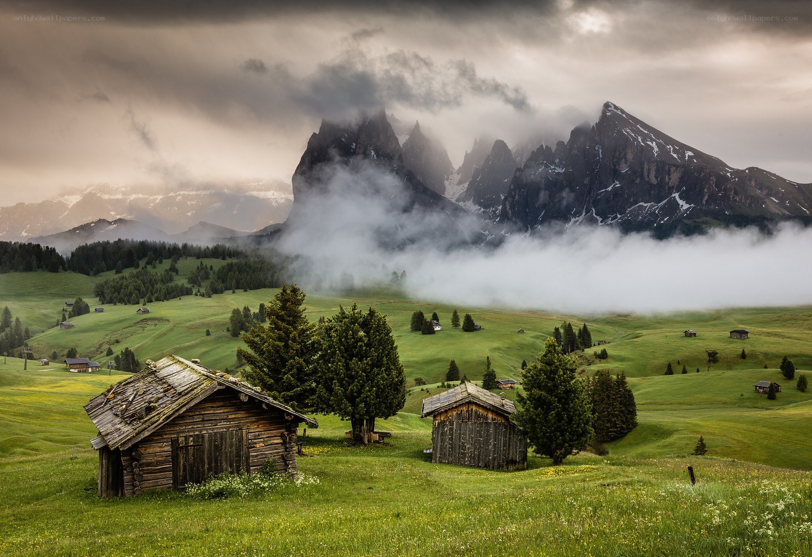 Mountain cabins in a misty valley
