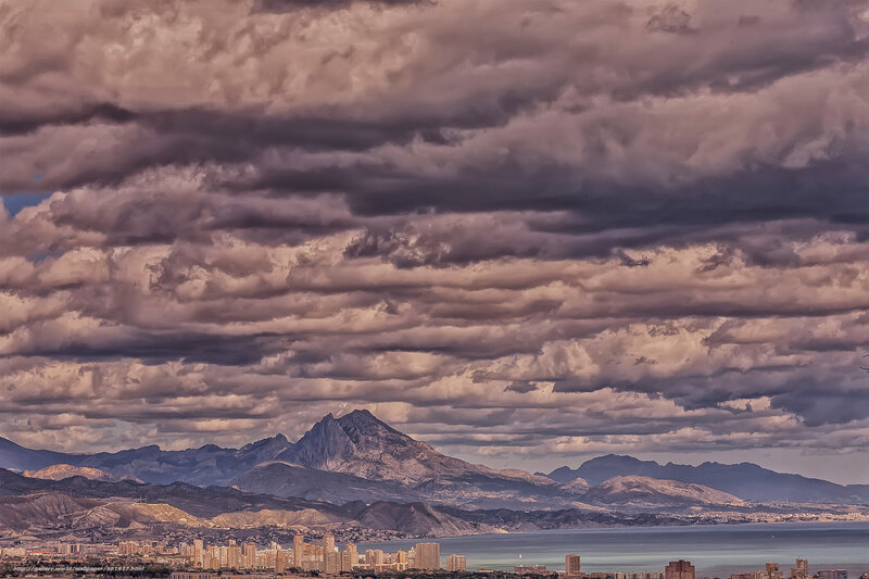 Mountain cityscape under cloudy sky