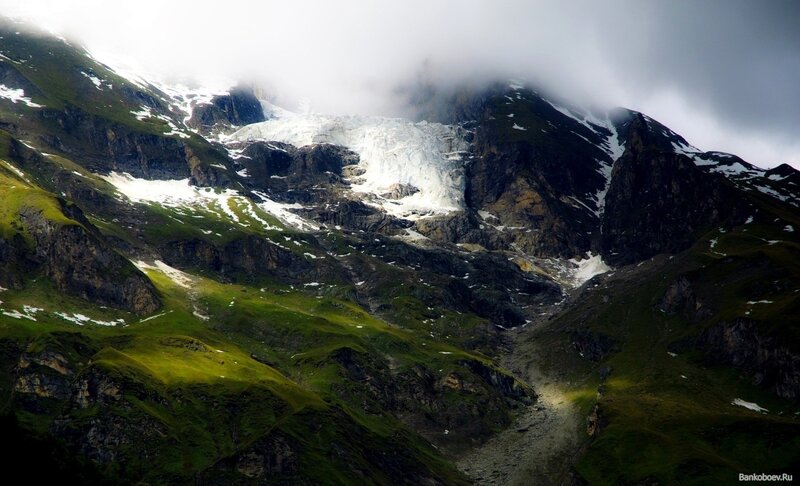 Mountain glacier under clouds