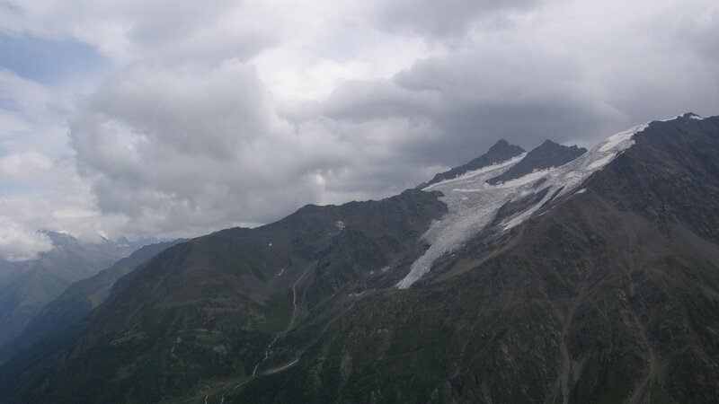 mountain glacier under cloudy sky