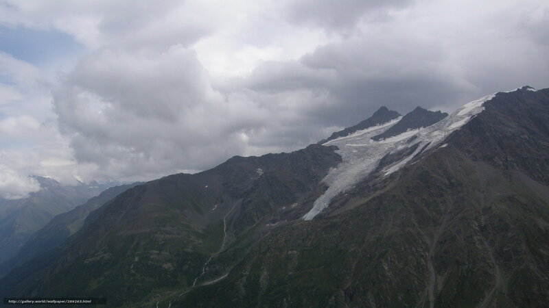 Mountain glacier under cloudy sky