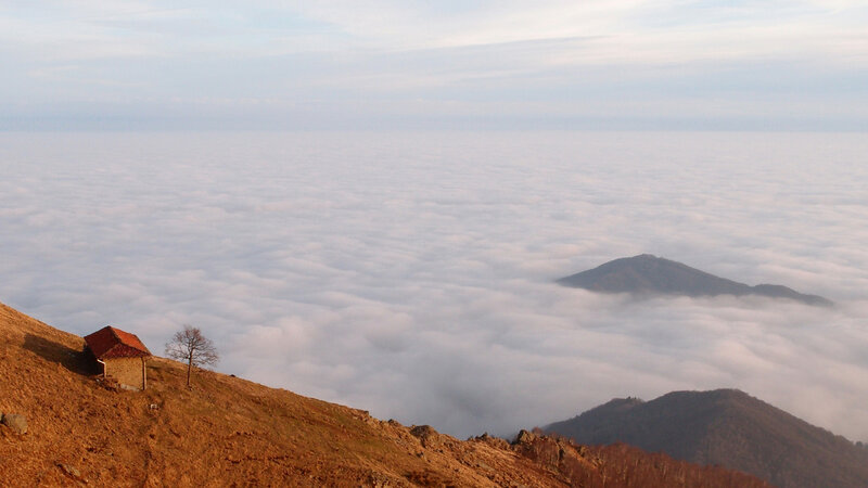 Mountain Hut Above Clouds — Brown